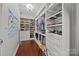 Custom walk-in closet with ample shelving, drawers, and organized storage space at 15913 Robbins Green Dr, Cornelius, NC 28031