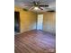 Living room with wood look flooring, ceiling fan and white door at 1612 Carter Rd, Lancaster, SC 29720