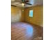 This living room offers wood look flooring and a window with natural lighting at 1612 Carter Rd, Lancaster, SC 29720