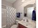 Well-lit bathroom with a vanity, mirror, and shower featuring floral curtain at 1796 Williamsburg Dr, Rock Hill, SC 29732
