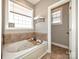 Relaxing bathroom with a soaking tub and a window with natural light at 1796 Williamsburg Dr, Rock Hill, SC 29732