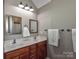 Bathroom features a double vanity, wood cabinets, and updated mirrors at 1796 Williamsburg Dr, Rock Hill, SC 29732