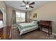 Cozy bedroom with ceiling fan, window, and carpet flooring at 1796 Williamsburg Dr, Rock Hill, SC 29732