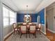 Formal dining room featuring blue accent wall, decorative chandelier, and large window at 1796 Williamsburg Dr, Rock Hill, SC 29732