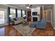 Comfortable living room with fireplace and built-in bookshelves, hardwood floors, and large windows at 1796 Williamsburg Dr, Rock Hill, SC 29732
