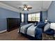 Comfortable main bedroom with blue walls, large bed, and plenty of natural light at 1796 Williamsburg Dr, Rock Hill, SC 29732