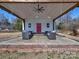 Outbuilding with cozy outdoor seating area and a bright pink door at 1796 Williamsburg Dr, Rock Hill, SC 29732