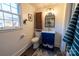 Renovated bathroom with modern vanity, new fixtures, tiled floors, and a window for natural light at 1839 Woodland Dr, Charlotte, NC 28205