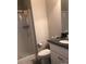 Bathroom with a vanity featuring granite countertop, toilet, and tiled shower with clear sliding doors at 194 Hattaway Cir, Mount Gilead, NC 27306