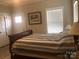 Cozy bedroom with a striped bedspread, a window with blinds, and neutral wall decor for a warm feel at 194 Hattaway Cir, Mount Gilead, NC 27306