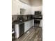 Modern kitchen featuring stainless steel appliances, granite countertops, and sleek white cabinets at 194 Hattaway Cir, Mount Gilead, NC 27306