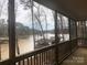 Enjoy waterfront living with this home's screened porch with views of the lake and boat docks at 194 Hattaway Cir, Mount Gilead, NC 27306