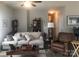 Inviting living room featuring a comfortable couch, leather chair, hardwood floors, and decorative shelving at 194 Hattaway Cir, Mount Gilead, NC 27306