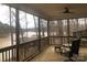 Enclosed porch with ceiling fan, screened siding, and waterfront views at 194 Hattaway Cir, Mount Gilead, NC 27306