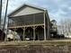 Spacious screened porch with backyard views and a covered area for golf cart and vehicle parking at 194 Hattaway Cir, Mount Gilead, NC 27306