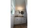 Bathroom with a double sink vanity featuring granite countertops and round black framed mirrors at 200 Hillcrest Ave, Hickory, NC 28601