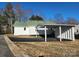 Exterior view of a charming home with a covered parking area and green roof at 200 Hillcrest Ave, Hickory, NC 28601