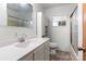 Bright bathroom featuring a large mirror, shower/tub combo, toilet, and built-in shelving unit at 208 Caleb Rd, Shelby, NC 28152