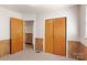 Cozy bedroom showing carpet, wood paneling, wooden doors and view into another room at 208 Caleb Rd, Shelby, NC 28152
