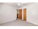 Bedroom boasts carpet, neutral paint, a ceiling fan, and two wooden doors at 208 Caleb Rd, Shelby, NC 28152