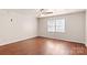 Bedroom boasts wood laminate flooring, neutral paint, a ceiling fan, and a window at 208 Caleb Rd, Shelby, NC 28152