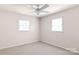 Bedroom featuring neutral walls, carpet, a ceiling fan, and two windows for natural light at 208 Caleb Rd, Shelby, NC 28152