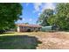 Charming brick home with green shutters and a covered carport, nestled under mature trees at 208 Caleb Rd, Shelby, NC 28152