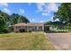 Charming brick home with a covered carport on a sunny day, showcasing its inviting facade at 208 Caleb Rd, Shelby, NC 28152
