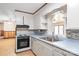 Bright kitchen featuring white cabinetry and a view into the dining area at 208 Caleb Rd, Shelby, NC 28152