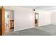 Carpeted living room featuring doorways to the bathroom and kitchen at 208 Caleb Rd, Shelby, NC 28152