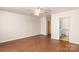 Sunlit living room with wood laminate flooring leading to a full bathroom with vanity and toilet at 208 Caleb Rd, Shelby, NC 28152