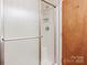Shower showcasing a sliding glass door, convenient shelving, and accessibility grab bar at 208 Caleb Rd, Shelby, NC 28152