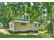 Backyard view of the home featuring an exterior door, steps, and lush green grass at 237 Mcneely Ave, Mooresville, NC 28115