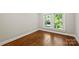 Well-lit bedroom with hardwood floors, neutral walls and plenty of light from the double windows at 237 Mcneely Ave, Mooresville, NC 28115