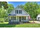 Charming bungalow-style home with a front porch, gray shutters, and an American flag at 237 Mcneely Ave, Mooresville, NC 28115
