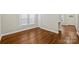 Bright living room featuring hardwood floors, neutral walls and ample natural light from the window at 237 Mcneely Ave, Mooresville, NC 28115