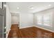 Bright living room with newly refinished hardwood floors and fresh paint at 237 Mcneely Ave, Mooresville, NC 28115