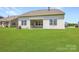 Spacious backyard featuring a covered patio with ample natural light and lush green lawn at 2811 Morning Song Way, Lancaster, SC 29720