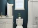 Cozy bathroom with stylish toilet, vanity, a large window, and teal accent wall at 2811 Morning Song Way, Lancaster, SC 29720