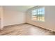Well-lit bedroom with luxury vinyl plank flooring and a window overlooking the neighborhood at 2811 Morning Song Way, Lancaster, SC 29720