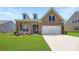 Charming brick home featuring a well-manicured lawn and a two-car garage, perfect for suburban living at 2811 Morning Song Way, Lancaster, SC 29720
