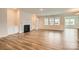 Bright and airy living room with luxury vinyl plank flooring, a fireplace, and built-in cabinets at 2811 Morning Song Way, Lancaster, SC 29720
