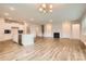 Open-concept kitchen and living area featuring an island with sink, fireplace, and modern lighting at 2811 Morning Song Way, Lancaster, SC 29720