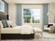 A luxurious main bedroom offering soft natural light, plush bedding, and cozy seating area at 2811 Morning Song Way, Lancaster, SC 29720