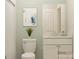 Neutral toned bathroom with a toilet, vanity, and an artwork at 2814 Morning Song Way, Lancaster, SC 29720