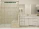 Bathroom features tiled shower with glass door, built-in bench, and a vanity with white cabinets at 2814 Morning Song Way, Lancaster, SC 29720