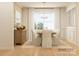 Elegant dining room with a wooden table, upholstered chairs, wainscoting, light-colored walls, and a chandelier at 2814 Morning Song Way, Lancaster, SC 29720