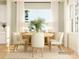 Bright dining room featuring a wood table, neutral chairs, and large windows dressed with white curtains at 2814 Morning Song Way, Lancaster, SC 29720