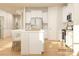 Bright, open kitchen featuring an island with white countertops and bar stool seating, stainless steel appliances and hardwood floors at 2814 Morning Song Way, Lancaster, SC 29720