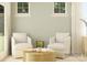 Cozy living room features neutral furniture, woven coffee table, and natural light from two windows at 2814 Morning Song Way, Lancaster, SC 29720